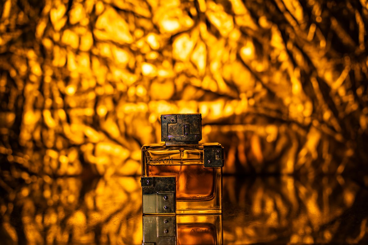 Perfume bottle in a dramatic golden-lit still life